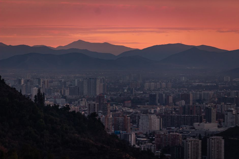 Chile: Spectacular dusk over Santiago's skyline with Andes mountains backdrop.